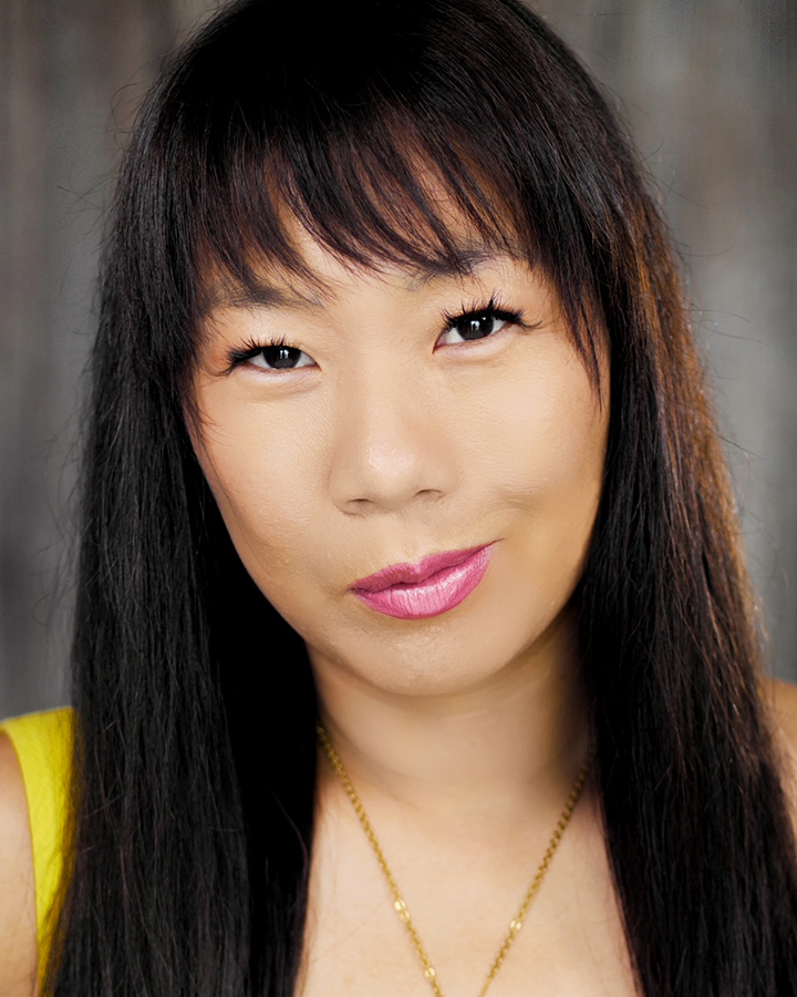 Headshot of an Asian woman in a yellow blouse